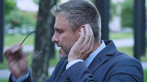 Middle-aged man suffering headache and panic attack, breathing fresh air outdoor Stock Footage 160811078
