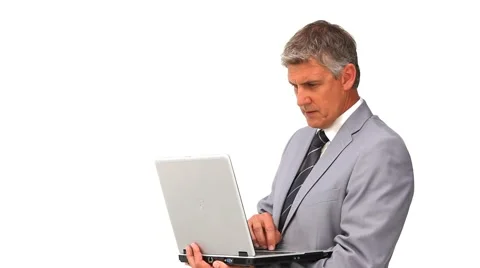 Middle aged man in suit standing with a laptop Vidéo 1097119