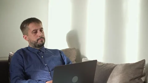 A middle-aged man surfs the Internet after work to relax. Video stock 168897091