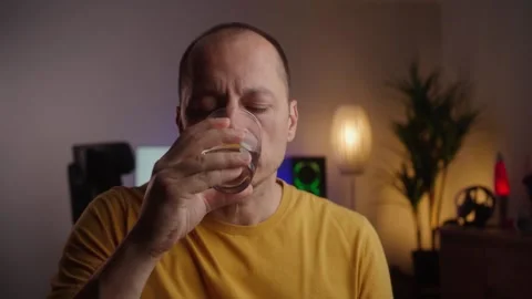 Middle aged man takes pill with glass of water in hand. Stock Footage 269990487