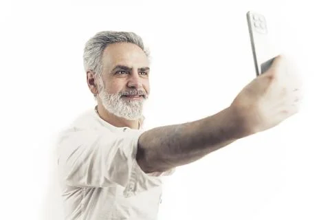 Middle-Aged man taking selfie using a smart phone isolated over white background Stock Photos