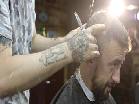 A middle-aged man talking and smiling in barbershop. Stock Footage 80075328