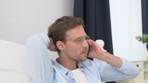 A Middle-aged Man Is Talking On The Phone In Bed Video stock 126121087