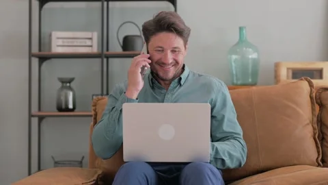 Middle Aged Man Talking on phone with Laptop in Lap Stock-Footage 287417270