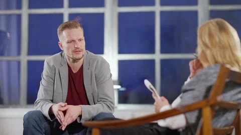 Middle aged man talking to psychologist during therapy session Stock Footage 142379223