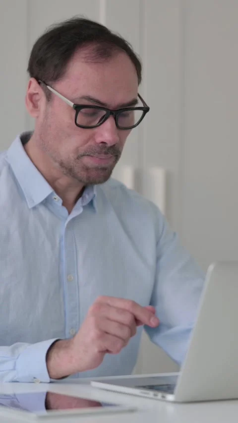 Middle Aged Man Talking on Video Call on Laptop in Office, Vertical Video 스톡 동영상 339584579