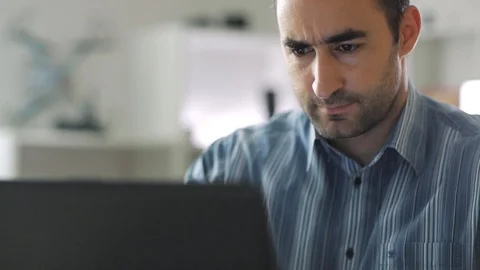 Middle aged man taping on the keyboard of the laptop computer while working a Stock Footage 112331145
