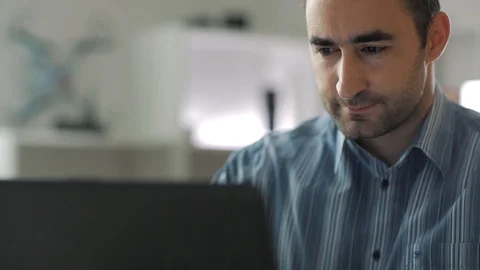 Middle aged man taping on the keyboard of the laptop computer while working a Stock Footage 112331194