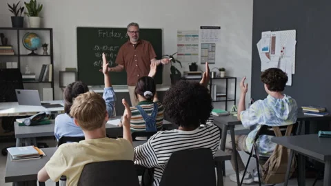 Middle Aged Man Teaching Math to Multiethnic Teenagers Raising Hands Stock Footage 339673513
