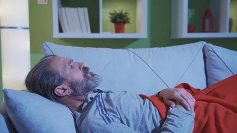 A middle-aged man with a terrible nightmare wakes up from his night's sleep. Stock Footage 230981946
