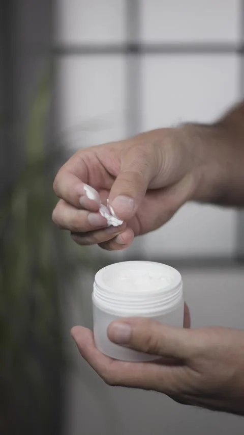 Middle aged man testing cream texture with fingers vertical video closeup Vídeos de archivo 342240207
