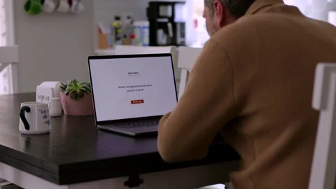 Middle Aged Man Testing Dad Joke Generator Website 動画素材 332947419