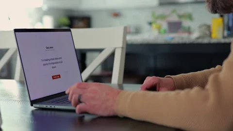 Middle Aged Man Testing Dad Joke Generator Website 動画素材 332947427