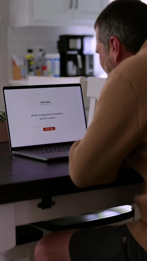 Middle Aged Man Testing Dad Joke Generator Website 動画素材 332947429