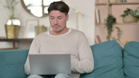 Middle Aged Man Thinking and Working on Laptop , at Home Stock Footage 142382163