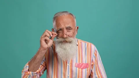 Middle aged man touch specs not see news isolated aquamarine color background Stock Footage 166690137