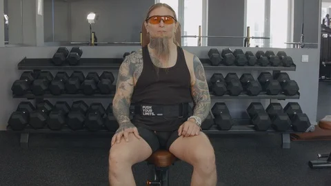 A middle-aged man trains biceps with dumbbells Stock Footage 115430553
