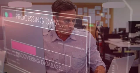 Middle-aged man typing at desk, HUD appearing over monitor, progress bar Stock Footage 334036604