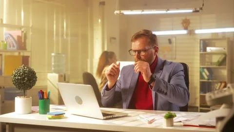 A middle aged man is typing on a laptop keyboard, suffering from vision problems Stock Footage 238507163
