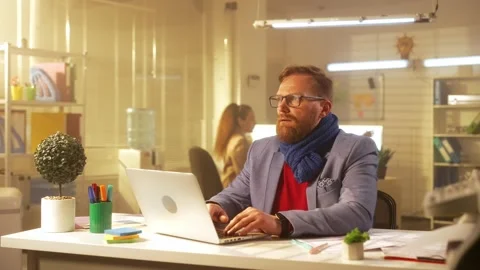 A middle aged man is typing on a laptop keyboard and suffers from fever and sore Stock Footage 238507257