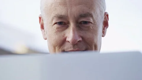 Middle aged man using a laptop outdoors Video stock 83637553