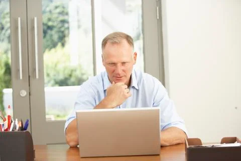 Middle Aged Man Using Laptop At Home Stock Photos