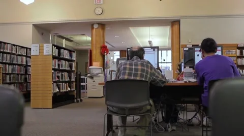 Middle Aged Man Using Library Computer Stock Footage 41663399