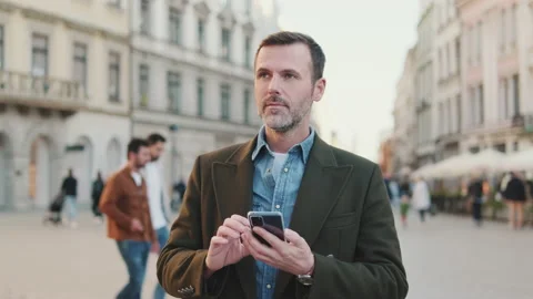 Middle aged man using map app on mobile phone Stock Footage 221530942