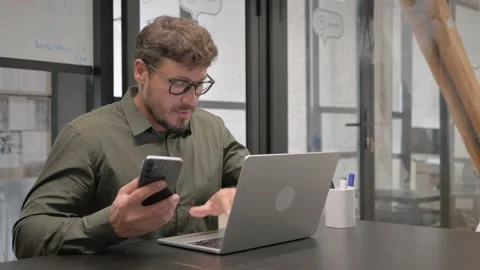 Middle Aged Man Using Multiple Devices for Work Stockbeeldmateriaal 307198780