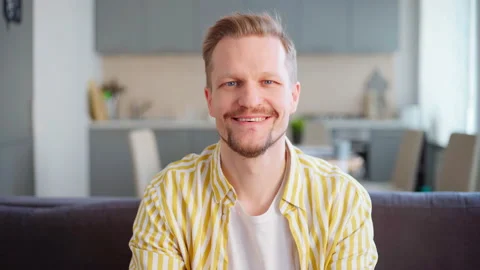 Middle aged man using phone and laughing at home Stock Footage 154737249