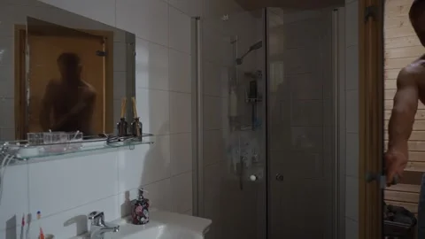 A middle-aged man using a private sauna in his apartment Stock Footage 303782648