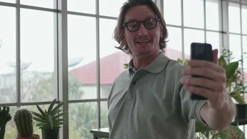 A middle-aged man is using a smartphone at a video conference. Stock Footage 142294076