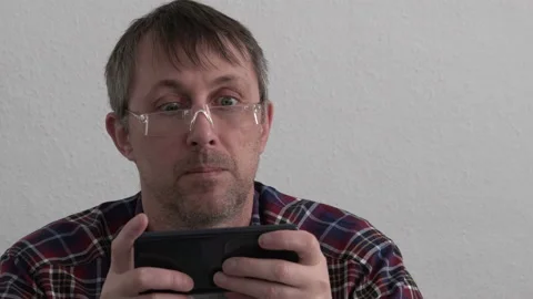 Middle Aged Man Using a Smartphone Stock Footage 154761791