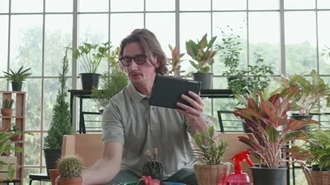 A middle-aged man is using a tablet computer at a video conference. Stock Footage 141126438