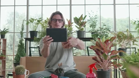 A middle-aged man is using a tablet computer at a video conference at home. Stock Footage 142294081