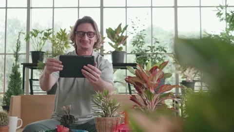 A middle-aged man is using a tablet computer at a video conference. Stock Footage 144002892