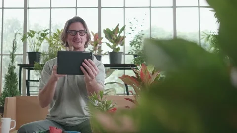 A middle-aged man is using a tablet computer at a video conference. Stock Footage 144002943