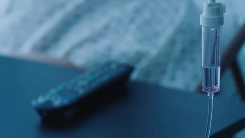 A middle aged man using a television remote control in a hospital bed, slow Stock Footage 74397467