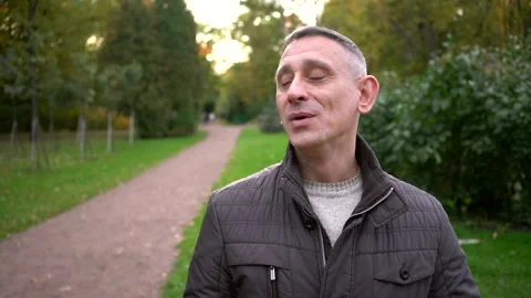 Middle Aged Man Vaping in spring Park Slow Motion Stock Footage 330102427