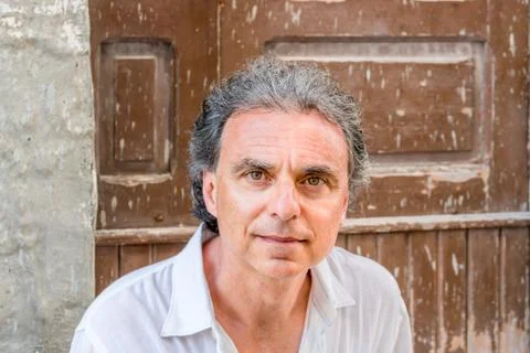 Middle-aged man visiting ancient town streets Stock Photos