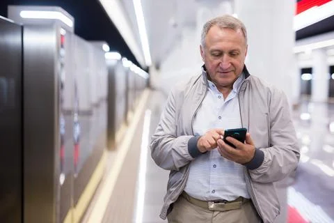 Middle aged man waiting for train in subway station Stock Photos