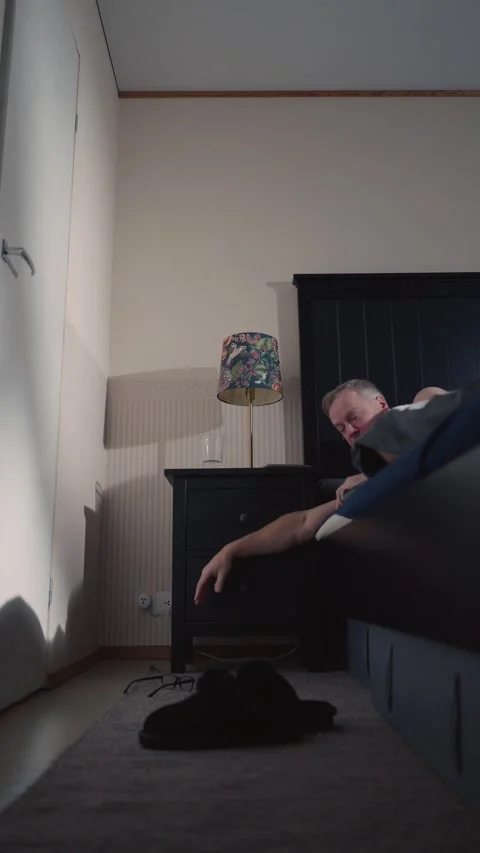 A middle-aged man waking up early before sunrise to start his day in Finland Stock Footage 303782472