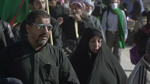 A middle aged man walking in Arbaeen pilgrimage in Karbala, Iraq Stock Footage 119248230