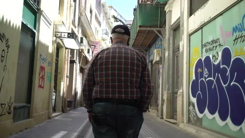Middle aged man walking back and legs gimbal shot Stock Footage 167839898