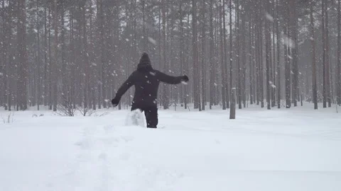 Middle aged man walks in snow shoes in forest and falls Stock Footage 231250320