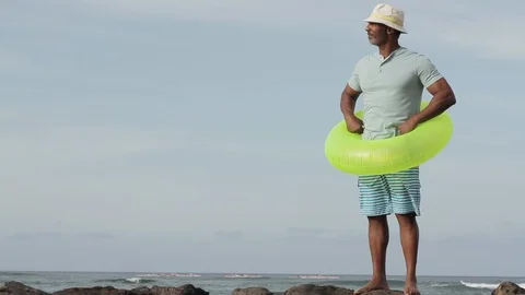 Middle-aged man wearing an inner tube laughing. 库存影片 88370921