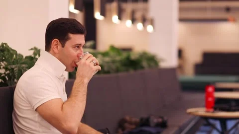 Middle-aged man in white drinks Stock Video Pond5