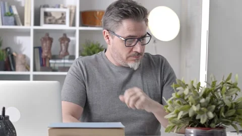 Middle aged man working with computer at home Stock Footage 148022246