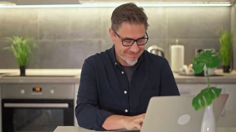 Middle aged man working with computer at home Видео 162682218