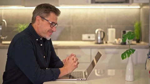 Middle aged man working with computer at home Stock Footage 162682264